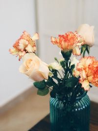 Close-up of flowers in vase on table at home