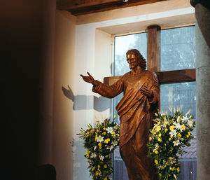 Statue of buddha against wall in building