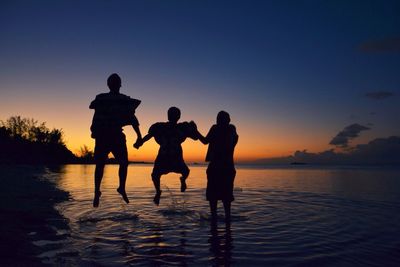 Silhouette of people at sunset