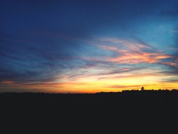 Silhouette landscape against sky during sunset