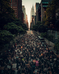 People on street amidst buildings in city