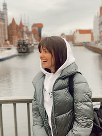 Portrait of a smiling young woman at canal