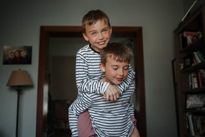 Portrait of smiling boy standing at home