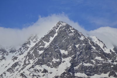 Scenic view of snow covered mountains against sky