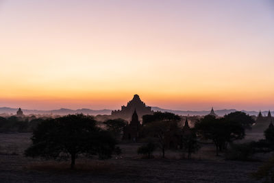 Scenic view of historic building against sky during sunset