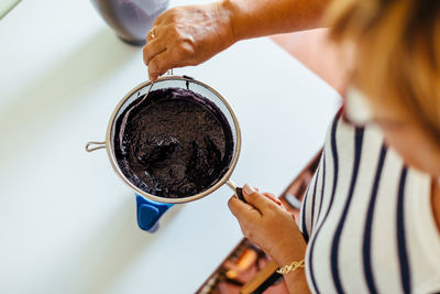 Midsection of woman holding coffee cup