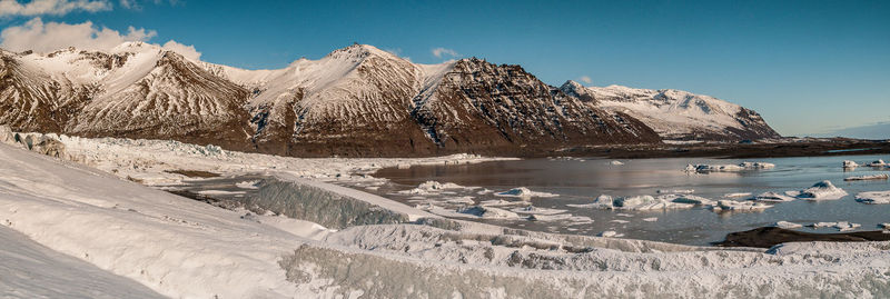 Scenic view of snowcapped mountains against sky during winter