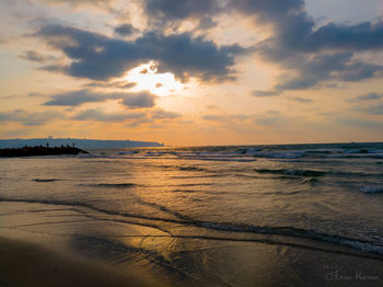 Scenic view of beach against sky during sunset