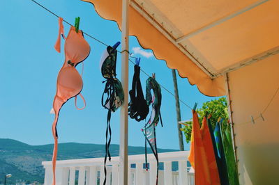 Low angle view of clothes drying against sky