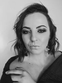 Portrait of beautiful woman against white background