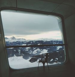 Snow covered landscape seen through window