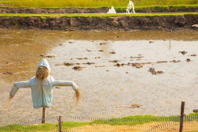 Rear view of woman walking on field