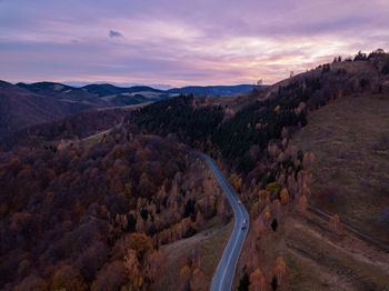 High angle view of road amidst landscape against sky during sunset
