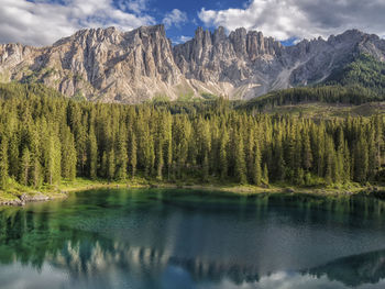 Scenic view of alpine lake and mountains against sky in dolomites region