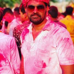 Portrait of man wearing sunglasses during holi celebration