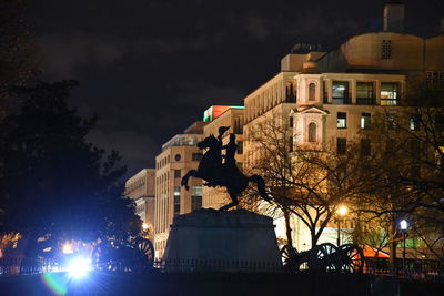 Low angle view of buildings against sky at night