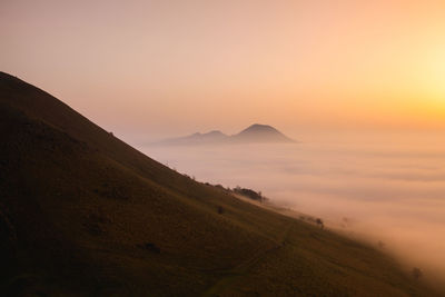 Scenic view of mountains against sky during sunset