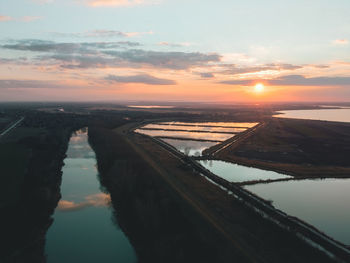 Scenic view of river against sky during sunset