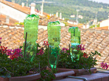 Bottles on a balcony used for irrigation system 