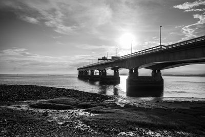 Low angle view of bridge over sea against sky