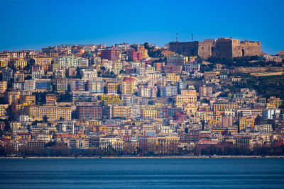 Distant view of buildings of naples waterfront, italy