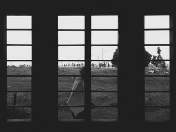 Silhouette people seen through window