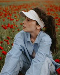 Portrait of young woman sitting on field