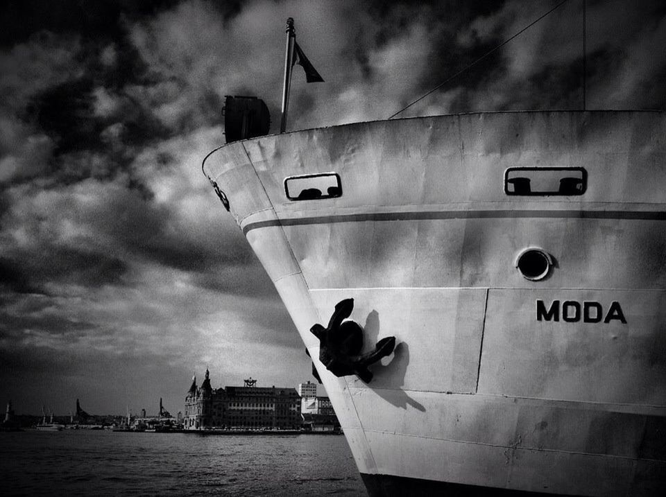 sky, building exterior, cloud - sky, architecture, built structure, guidance, men, lifestyles, cloudy, holding, cloud, city, transportation, leisure activity, travel, nautical vessel, water, outdoors