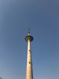 Low angle view of communications tower against clear sky