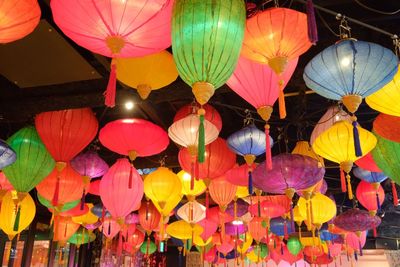 Low angle view of illuminated lanterns hanging at night