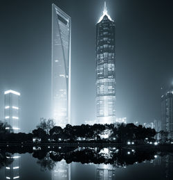 Illuminated modern buildings in city at night