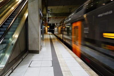 Blurred motion of train at railroad station