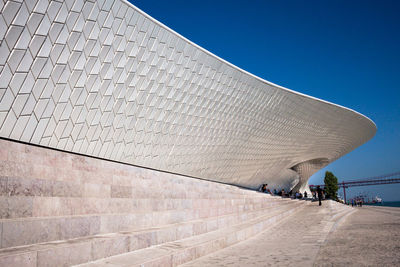 Low angle view of footpath against clear blue sky