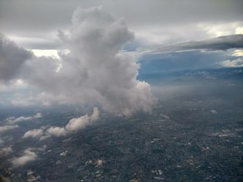 Aerial view of landscape against cloudy sky