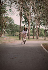 Rear view of woman walking on road