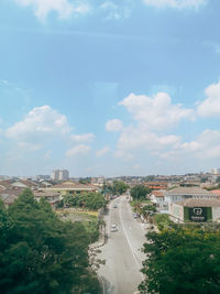 High angle view of road by buildings against sky