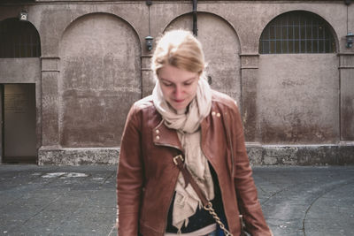 Woman looking at camera in city