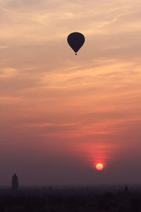 Silhouette hot air balloon against sky during sunset
