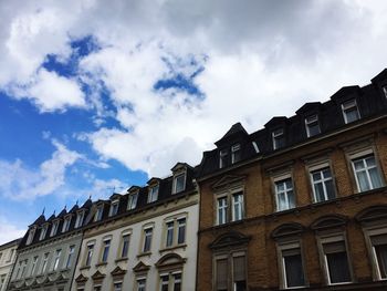 Low angle view of building against cloudy sky