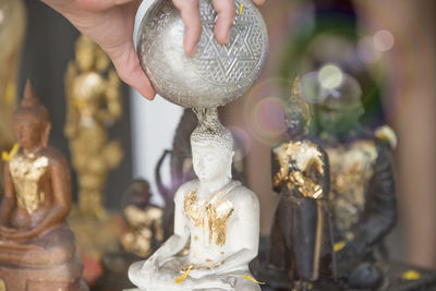 Close-up of hand holding statue