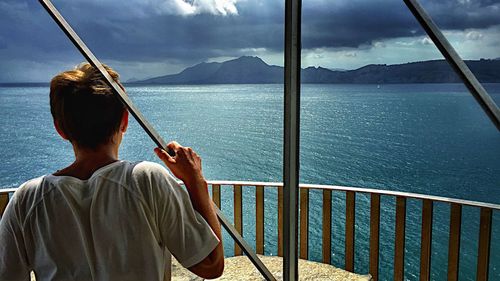 Rear view of woman looking at sea