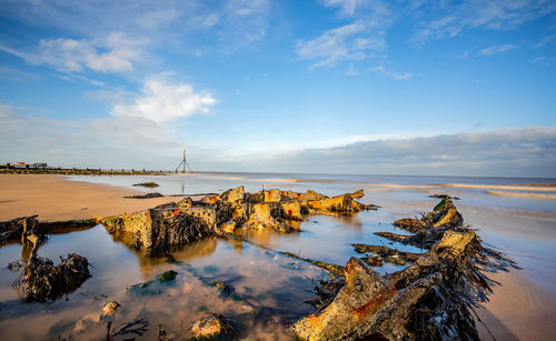 Long exposure photo of rock pool on a sandy beach