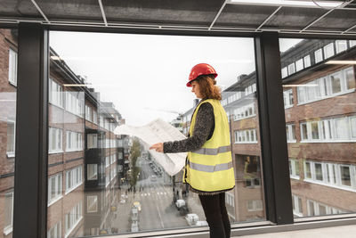 Female worker looking at blueprints