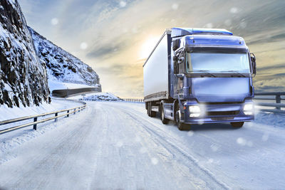 Truck on snow covered road during snowfall