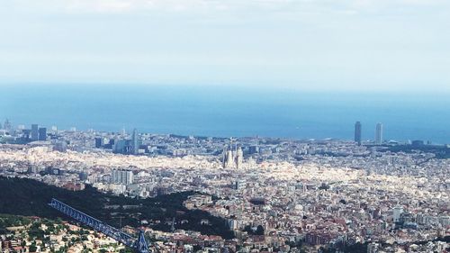 High angle view of city buildings against sky