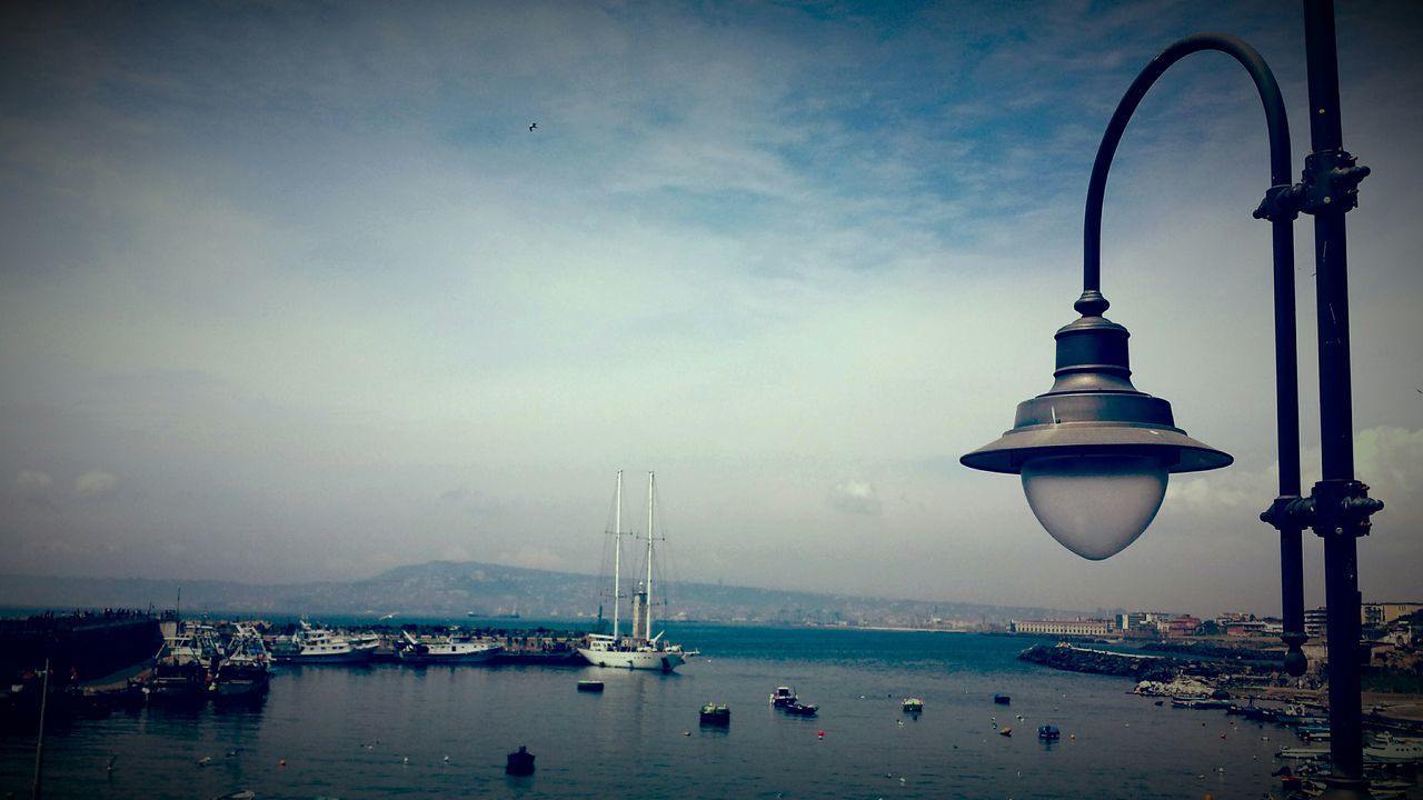 water, sea, nautical vessel, transportation, sky, mode of transport, boat, waterfront, bird, sailboat, harbor, mast, nature, moored, cloud - sky, animal themes, flying, outdoors, travel, commercial dock