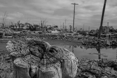 Fishing net on harbor against sky