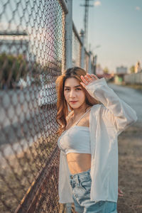 Portrait of young woman standing outdoors