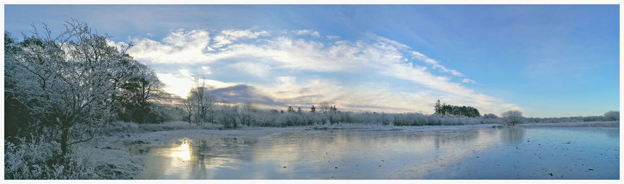 Panoramic view of lake against sky during winter