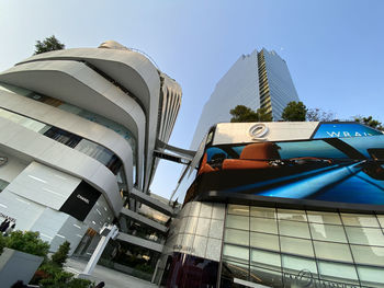 Low angle view of modern buildings against clear blue sky